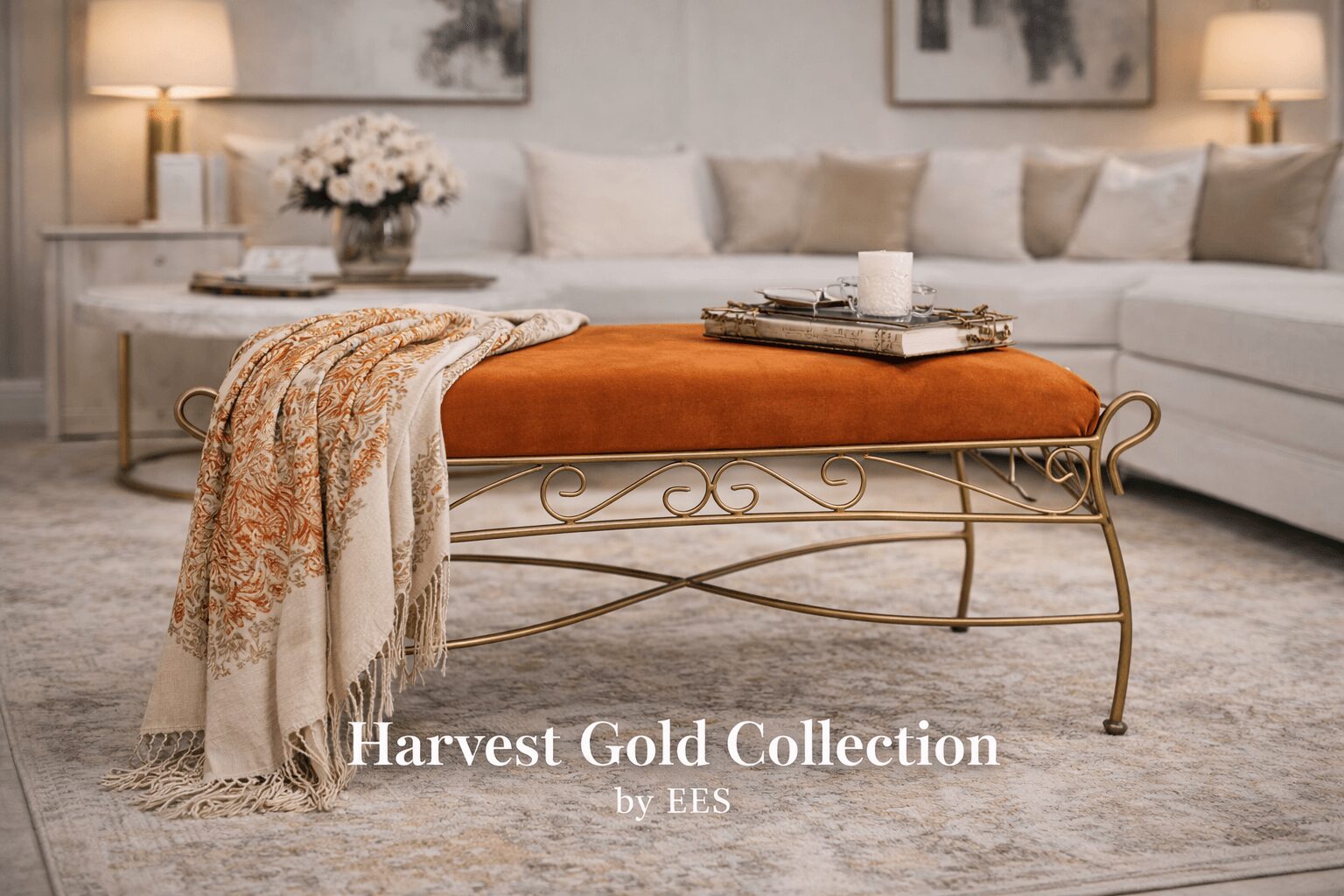 Living room with a gold-colored bench, blanket, books, and a sofa with cushions, in a cozy setting.