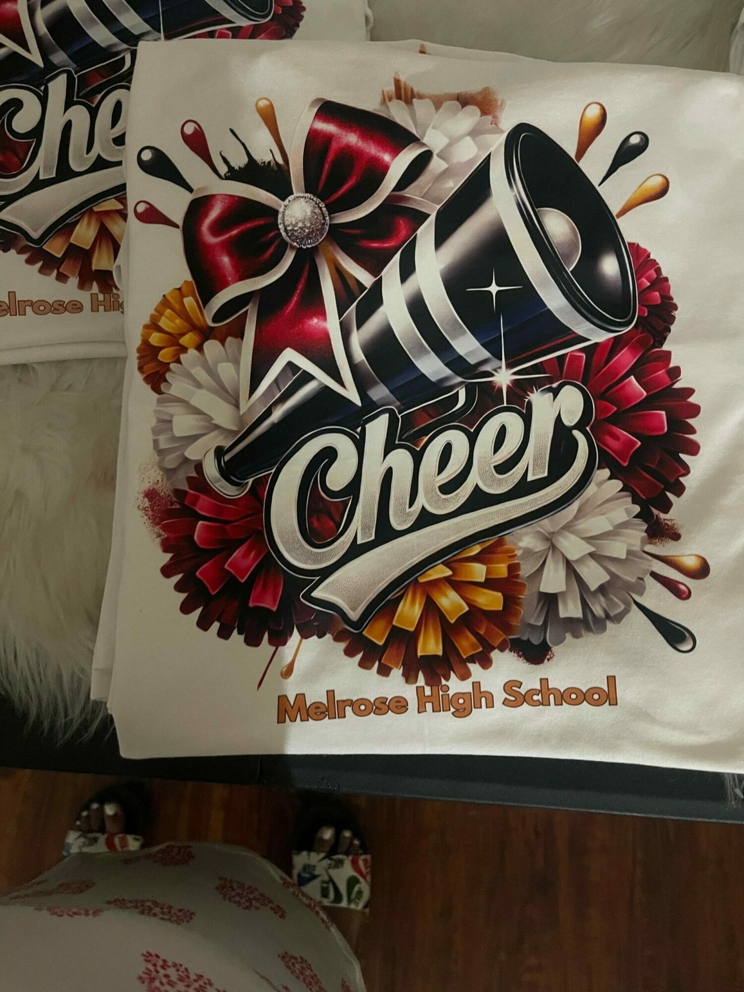 Cheerful school-themed poster with a megaphone, colorful flowers, and the word Cheer, with text 'Montessori School' on the side.