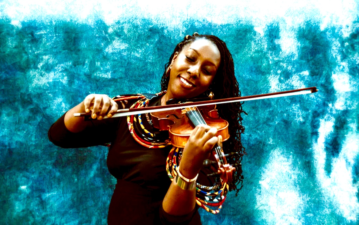 Woman playing violin with a bow, smiling, against a blue textured background.