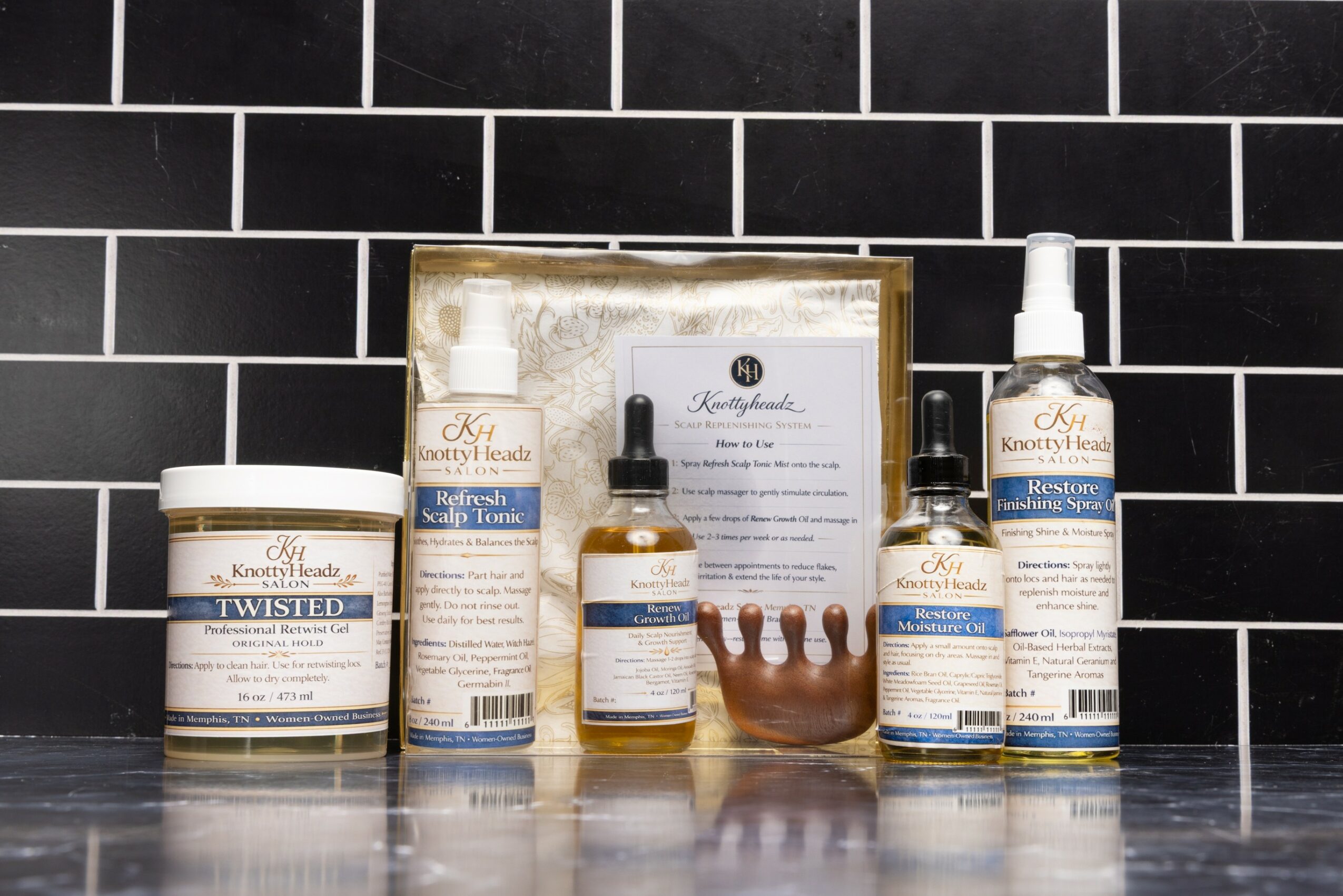 Collection of skincare products and a certificate on a black tiled surface, with a small decorative crown in the center.